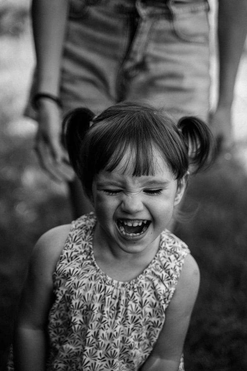 black and white photograph of a laughing girl